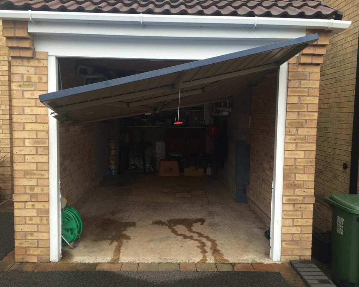 Broken garage door that is trying to be opened